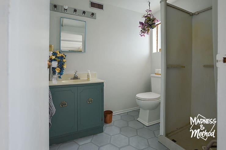 basement bathroom before painted floors teal vanity