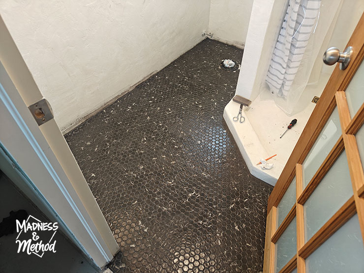 wiping grout from black hex floors