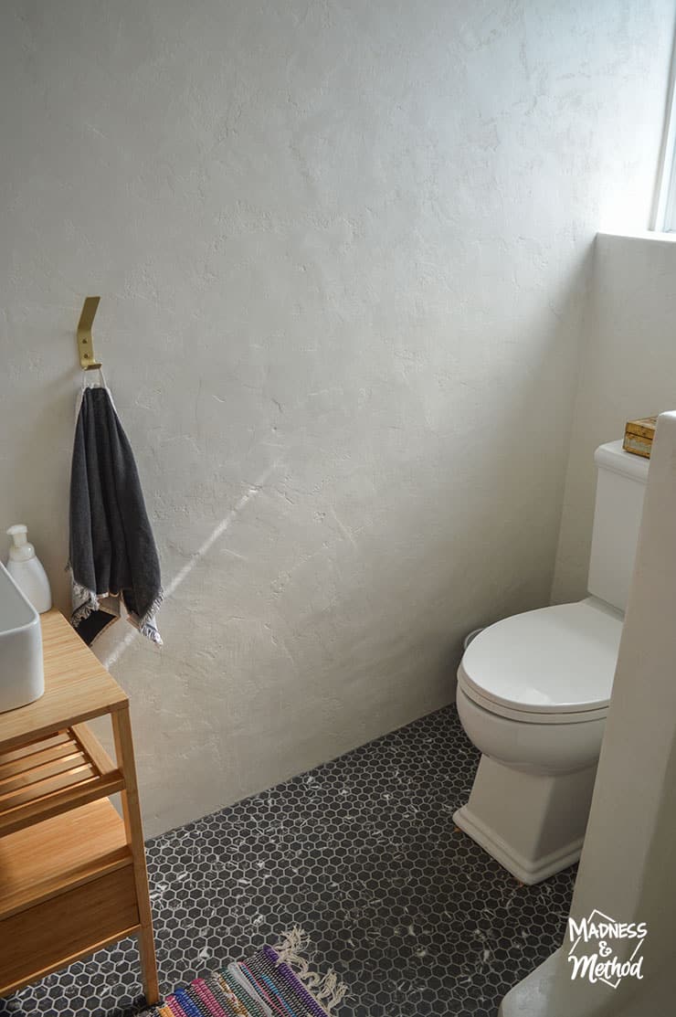 white microcement bathroom walls black floors