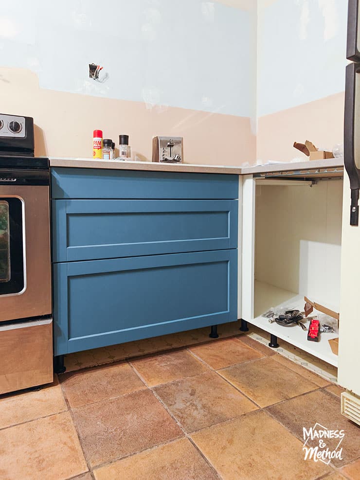 blue ikea cabinet with terracotta floors