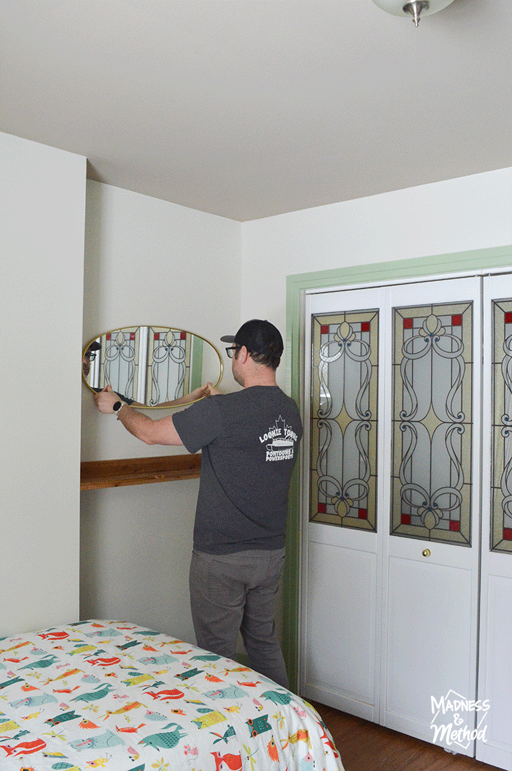 mirror above floating shelf